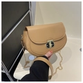 Close-up of khaki saddle bag with elegant gold metal twist-lock and chain strap - Khaki
