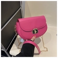 Detail of rose pink saddle bag with gold metal twist lock and chain shoulder strap - Rose Pink