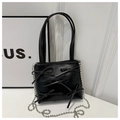 Close-up of black PU leather bucket bag featuring decorative bows and silver bead chain - Black