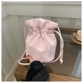 Close-up of light pink drawstring bucket bag with unique crinkled fabric texture - Pink