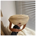 Close-up of handmade woven straw waist bag with adjustable brown canvas shoulder strap - Dark Brown
