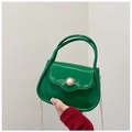 Close-up of green mini PVC bag with pearl buckle and golden chain strap - Green