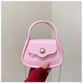 Close-up of pink PVC mini bag featuring a large pearl clasp and gold chain strap - Pink