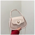 Close-up of mini PVC jelly bag in light pink with a pearl buckle and golden chain - Khaki