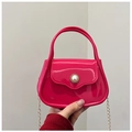 Detail view of rose red jelly handbag featuring a pearl buckle and gold chain strap - Rose Red