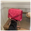 Detail of rose pink quilted chain bag with vertical wave stitching and gold hardware - Rose Red