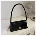 Chic black patent leather baguette shoulder bag with gold clasp in minimalist setting - Black
