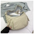 Detail of cream nylon crescent bag with woven zipper pull and adjustable wide strap - Off White