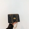 Elegant black quilted crossbody bag with gold chain strap and metallic closure - Black