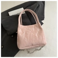 Detail of light pink bucket bag with pleated PU leather texture and silver chain strap - Pink