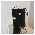 Detail of black vintage style cell phone bag with white pearl buckle and elegant long tassel - Black