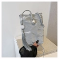 Detail of silver pleated fabric bag with pearl closure and long floral tassel accent - Silver