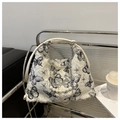 Detail of white plush tote bag featuring black butterfly prints and pearl pendants - Black