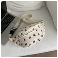 Detail of white corduroy saddle bag featuring cute strawberry print and adjustable strap - White