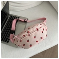 Detail of pink corduroy saddle bag featuring strawberry print and adjustable strap - Pink