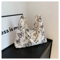 White butterfly embroidery tote bag with gold chain straps and textured fabric design - Black
