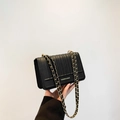 Elegant black quilted crossbody bag with gold chain strap and fashion logo detail - Black