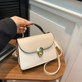 Elegant cream small square bag with golden twist lock and black trim edges - Khaki