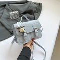 Light blue Cambridge satchel with double buckles and a cartoon girl charm decoration - Blue with Charm