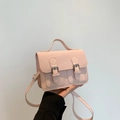 Pink Cambridge style crossbody bag with top handle and double buckle straps - Pink
