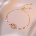 Adjustable gold clover bracelet with pink heart-shaped stones and cubic zirconia - Pink Rotating Heart Bracelet (TS0211)