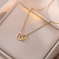 Minimalist double heart interlocking titanium steel necklace in gold on jewelry box - Interlocking Heart Necklace (T0016)
