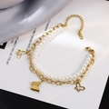 Titanium steel layered bracelet with pearls and butterfly charms on a satin background - Gold