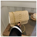 Detail of woven straw handbag featuring a gold S logo and fringe charm detail - Khaki