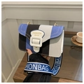Detail of small canvas crossbody bag featuring blue and black vertical stripes and wide strap - Striped Multi-color