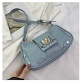 Details der hellblauen Krokodilledertasche mit Herzschnalle und Silbernieten - Blau
