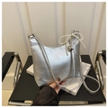 Detail of silver metallic shoulder bag with pearl bow, heart charm and fashion engraving - Silver