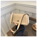 Detail of elegant beige square shoulder bag featuring a gold rectangular twist lock - Khaki