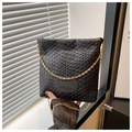 Close-up of black woven texture handbag with golden chain strap and embossed logo detail - Black