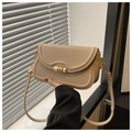 Close-up of a cream crossbody bag featuring a golden triple-ring lock and leather strap - Khaki