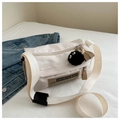 Detail of beige nylon crossbody bag with vintage sports label and black plush charm - With Pendant / White