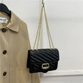 Chic black faux leather shoulder bag with V-shaped quilting and golden chain straps - Black