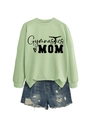 Close-up of Gymnastics Mom print on light green sweatshirt with denim shorts details - Olive Green (Black Font)