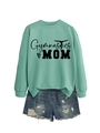 Flat lay of a mint green Gymnastics Mom sweatshirt paired with distressed denim shorts - Light Green (Black Text)