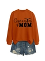 Flat lay detail of orange Gymnastics MOM sweatshirt paired with distressed denim shorts - Burnt Orange (Black Font)