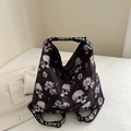 Large skull and floral print nylon tote bag with Love letter straps on white bedding - Fuschia