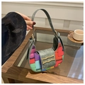 Detail of colorful geometric woven bag with golden butterfly clasp and gray strap - Patterned Green
