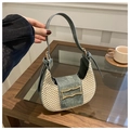 Detail of woven straw and denim baguette bag featuring a gold geometric buckle decoration - Green