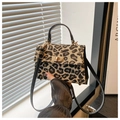 Detail of leopard print fabric texture and gold twist lock on women's crossbody bag - Leopard Black