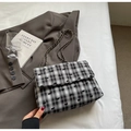 Detail of plaid tote bag featuring bow embroidery and woven metal chain strap - Black & White Check