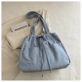 Detail of light blue canvas tote bag with drawstring closure and front pockets - Sky Blue