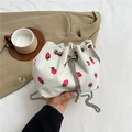 White corduroy bucket bag with red strawberry print and silver chain strap - White