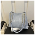 Detail of light blue tote bag with embossed Fashion text and gold chain strap - Blue