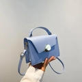 Light blue rectangular crossbody bag in matte leather with a unique silver metal clasp - Blue