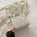 White denim square tote bag with fringed edges and quilted texture on light blazer - White