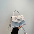 White trapezoid handbag with butterfly print and silver bow lock, top handle and strap - Black